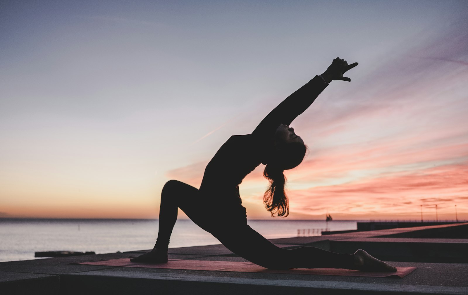 Woman practicing a flowing outdoor form in natural light